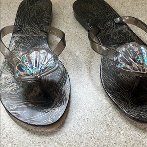 Elegant Black and Silver Women's Sandal
Melissa flip flop, black size 7